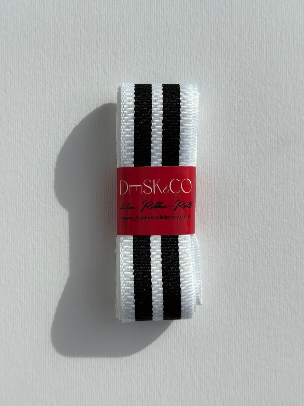 Premium Striped Grosgrain ribbon roll. Stripes include thick black and white stripes. Available in 2.5 metre rolls for stylish gift wrapping.