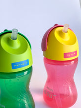 Load image into Gallery viewer, Kids&#39; green and pink drinking bottles each featuring a personalised kids&#39; permanent vinyl name labels for labelling their possessions. 
